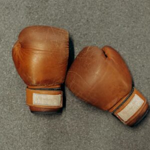 pair of boxing gloves on gray surface